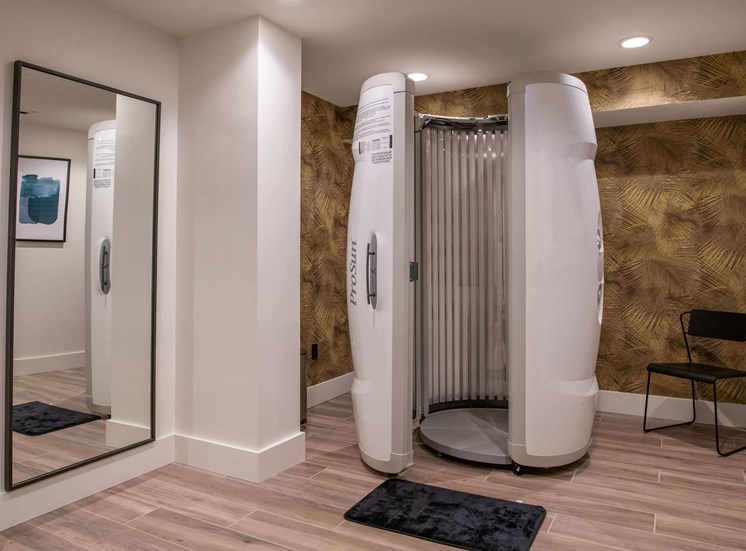 Prosun tanning bed in a room with a chair and full length mirror